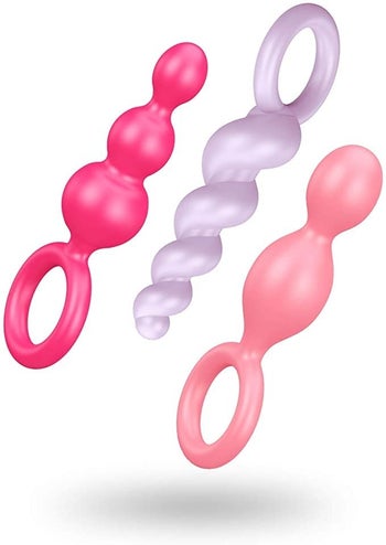 One hot pink anal plug, one light purple anal plug and one light pink plug with different textures