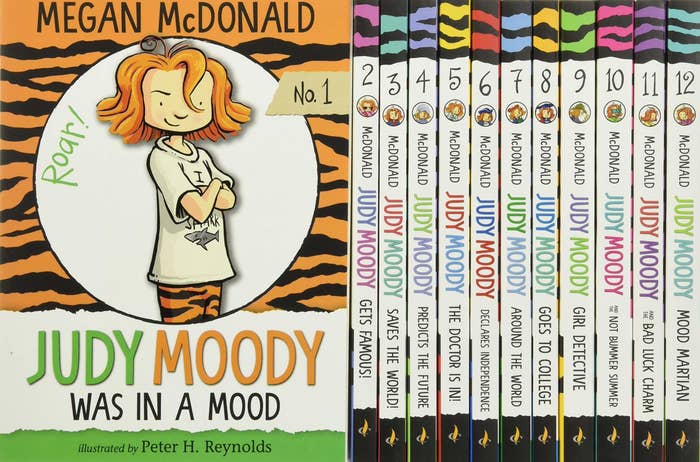 A stack of Judy Moody books, featuring one with her on the cover, a girl with short red hair and her arms crossed, wearing tiger print pants. Book title reads: Judy Moody Was In A Mood