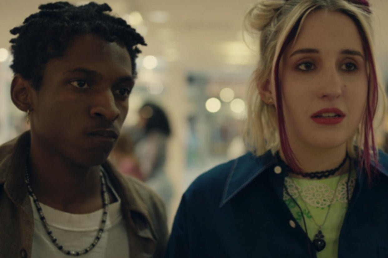 Vince and Mallor stand side by side as they are stopped by someone as they walk through a mall.