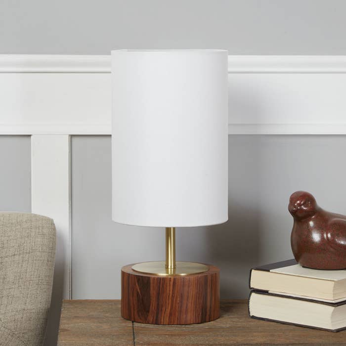 table lamp with white lampshade and wood base and brass finish