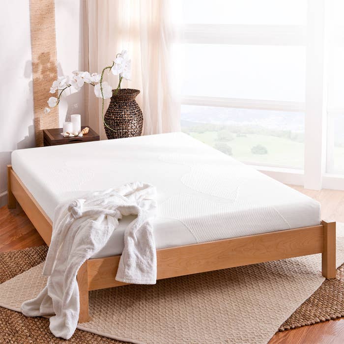memory foam mattress in a wood bedframe