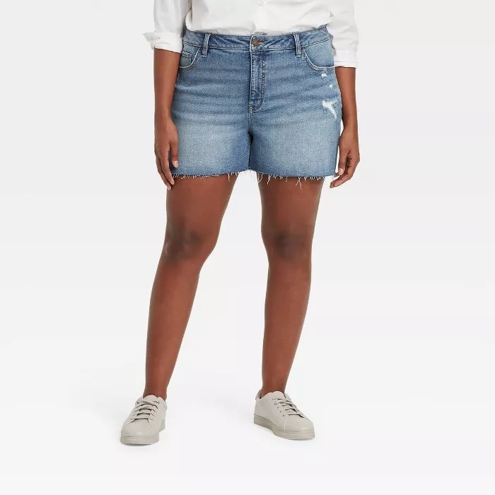 A model wearing jean shorts