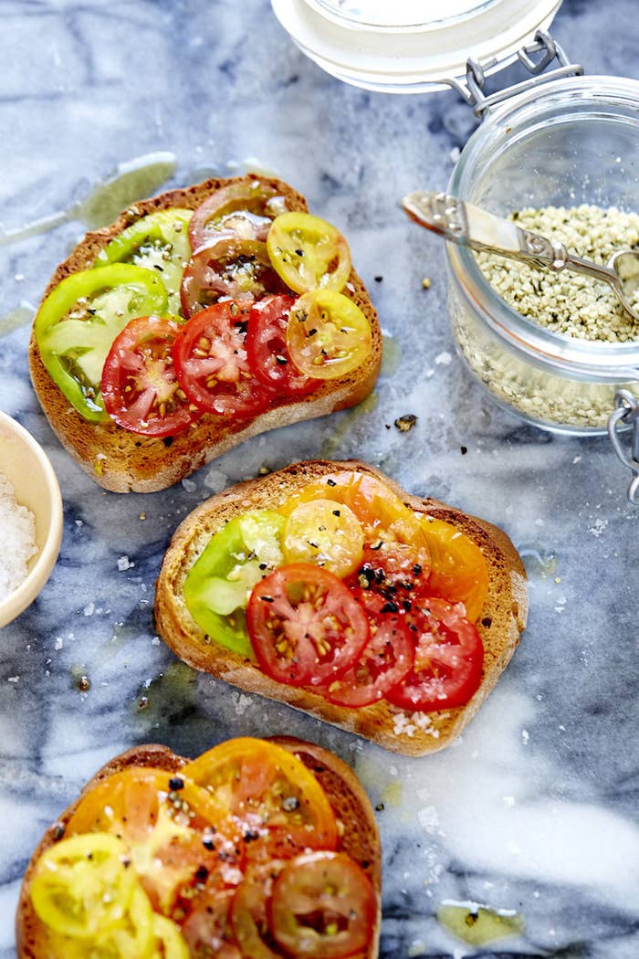 Toast topped with multi-colored tomatoes.