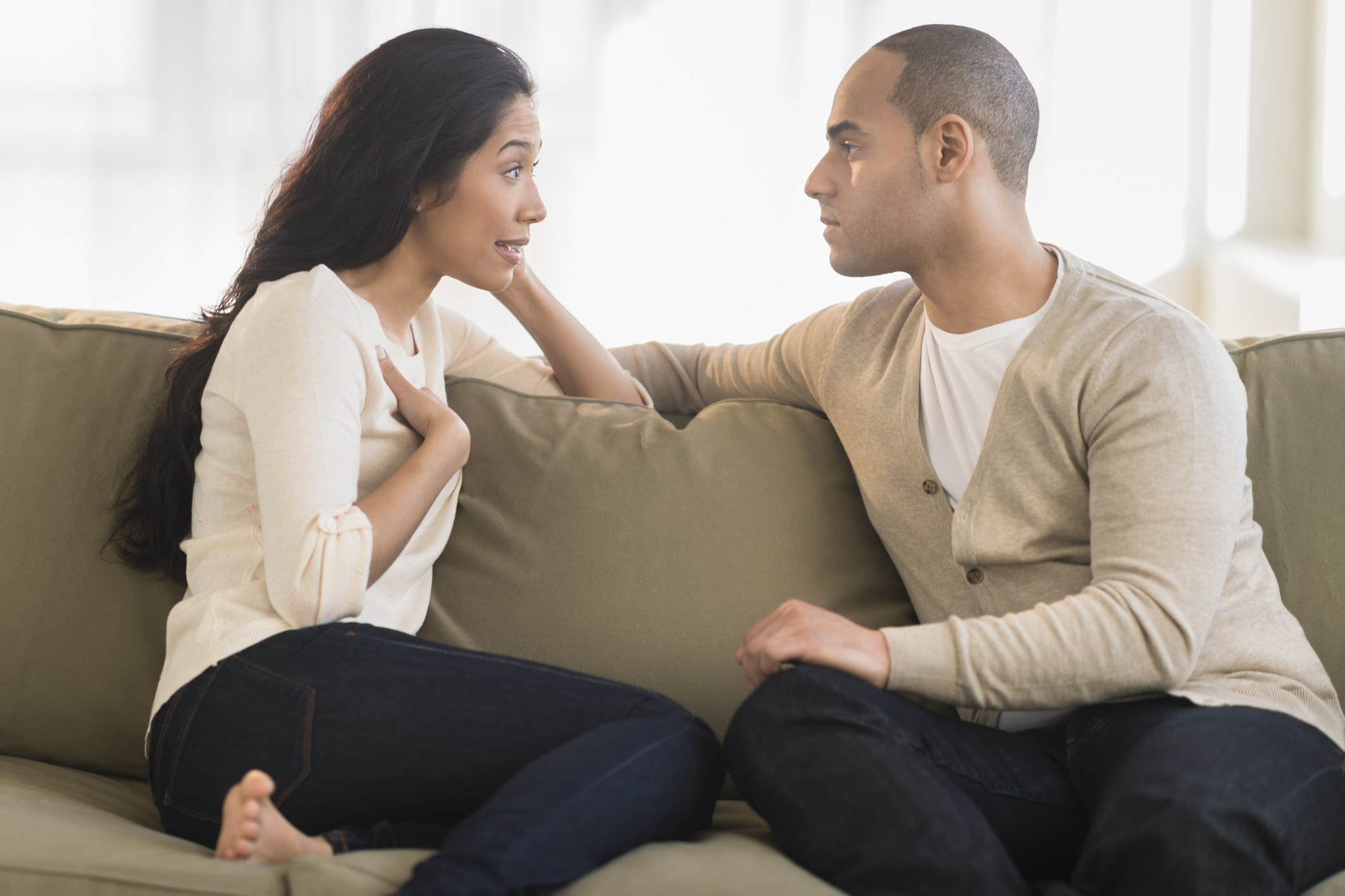 Couple talking on couch. 