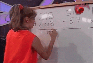 A woman writes down the wrong answer to a math problem on a whiteboard