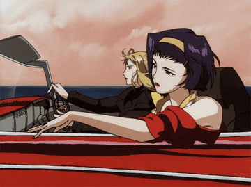 Two women driving in a red convertible