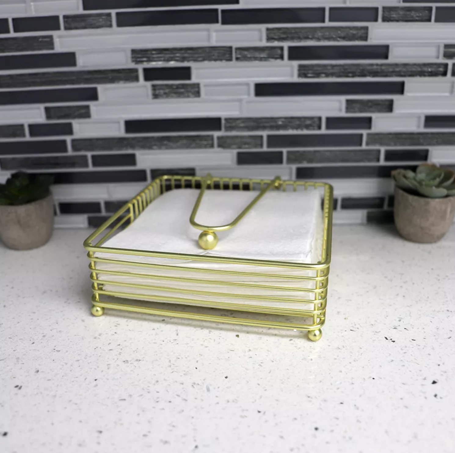 the napkin holder with white napkins