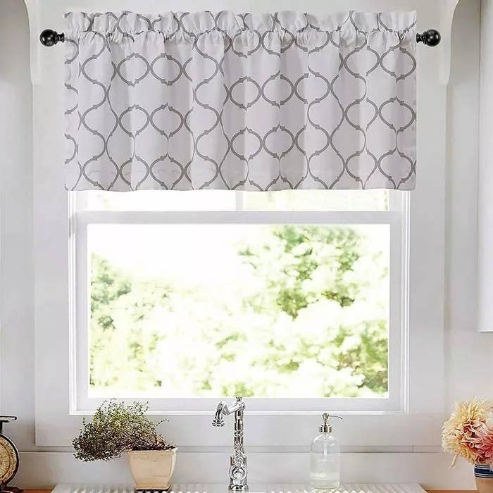 A white and gray window valance