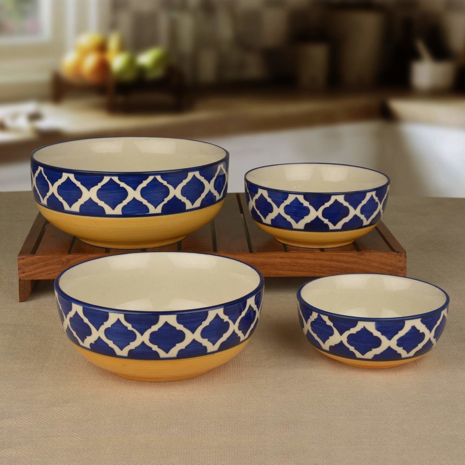 Four ceramic bowls on a table with a blue and yellow design