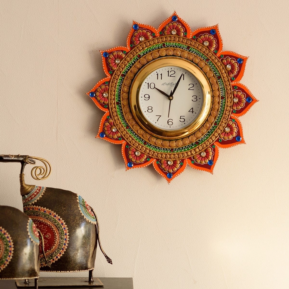 A wall clock with a floral pattern on it on the wall