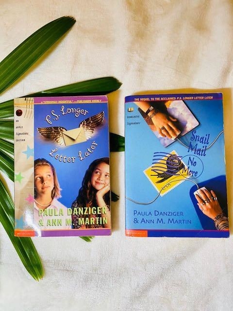 Two books, P.S. Longer Letter Later and Snail Mail No More, both with blue covers; one features two young girls, and one features two hands on mousepads