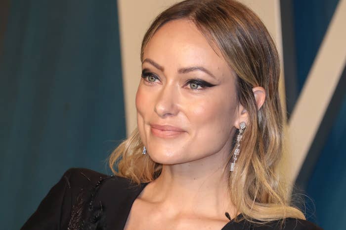 Olivia Wilde is photographed smiling at a red carpet event