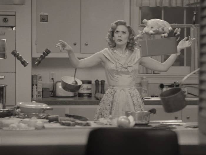 wanda maximoff in 50s womens dress in kitchen, food floating in the air