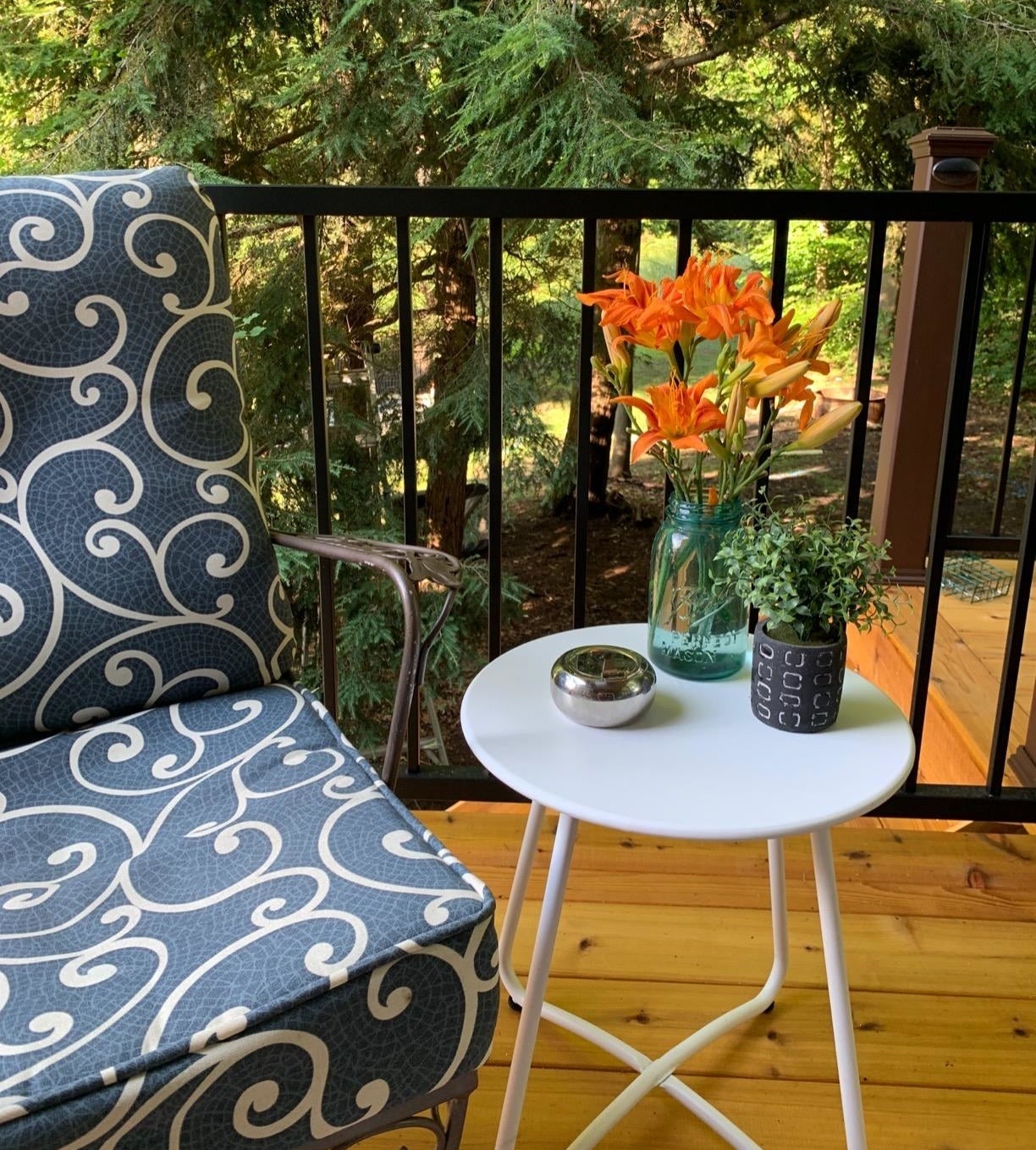 Reviewer photo of the metal side table in white next to a blue chair