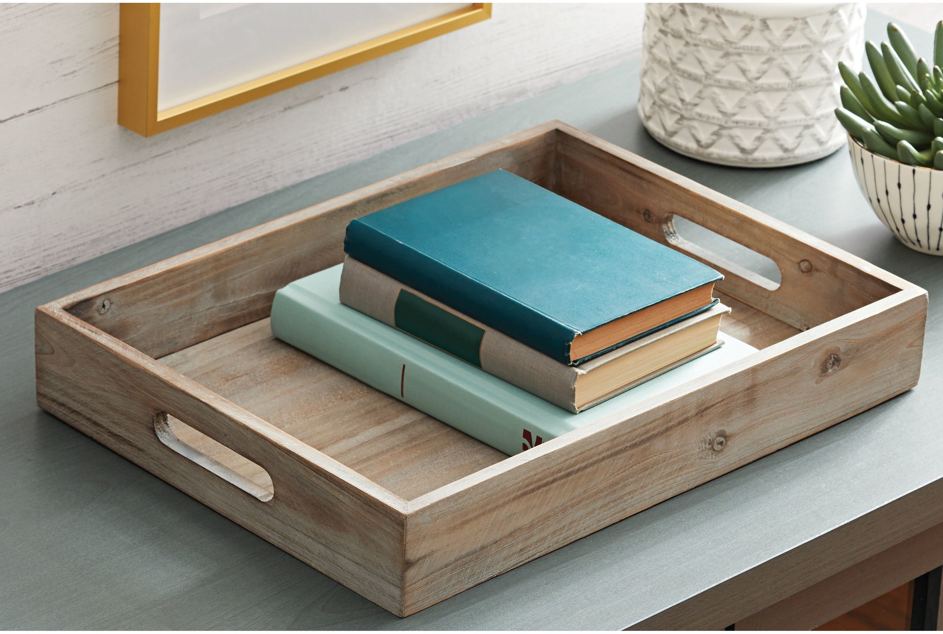 grey wash wooden tray handles on a tabletop with books inside