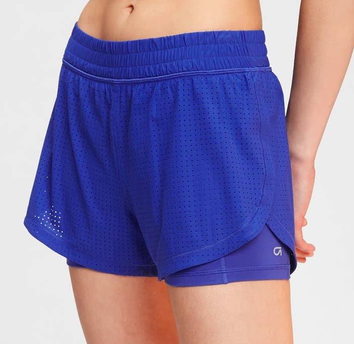 A person wearing the shorts with the bottom layer peaking through