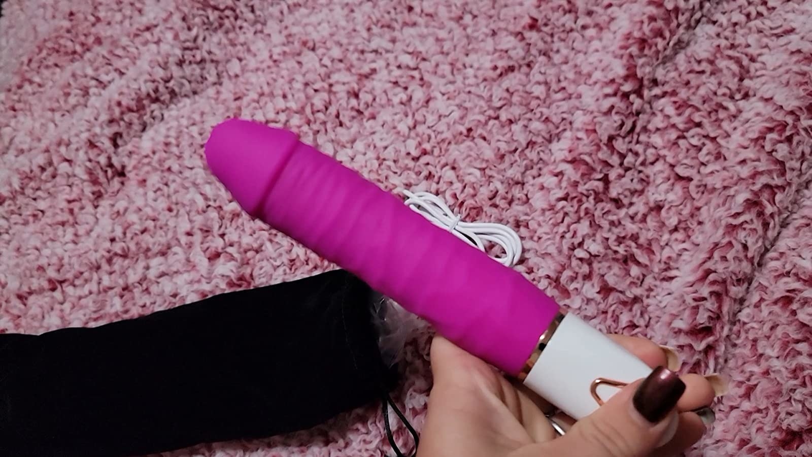 Model holding pink and white realistic vibrator
