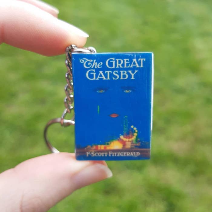 person holding up great gatsby keychain