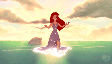 ariel from the little mermaid walking out of the sea in a sparkly dress