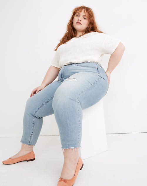 A model wears the jeans, seated