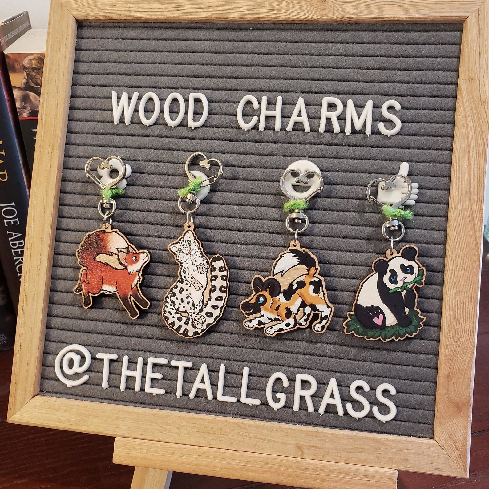 Four woodland charms of a fox, leopard, dog, and panda