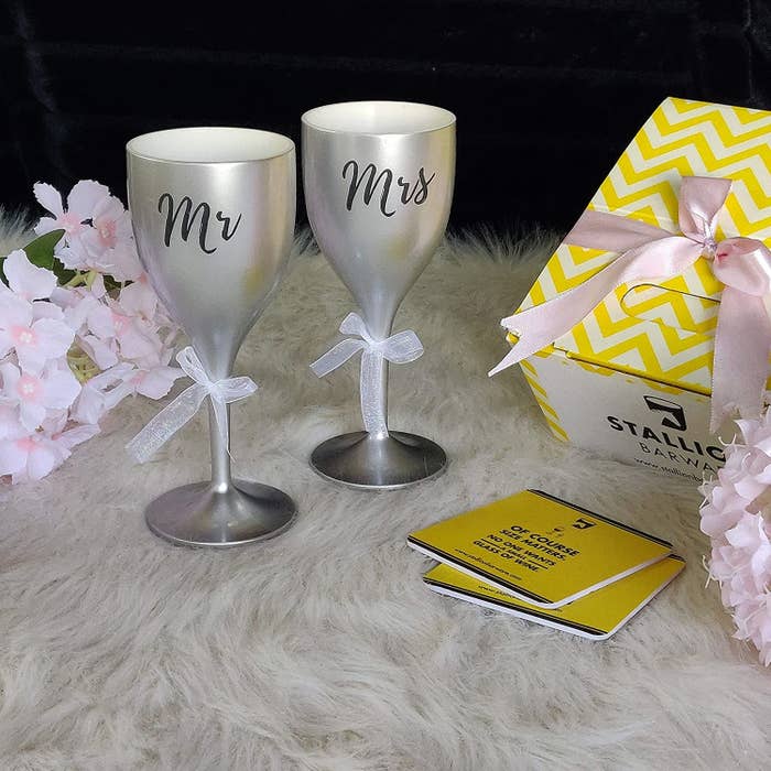 A pair of silver polycarbonate wine glasses with the Mr &amp;amp; Mrs printed on them