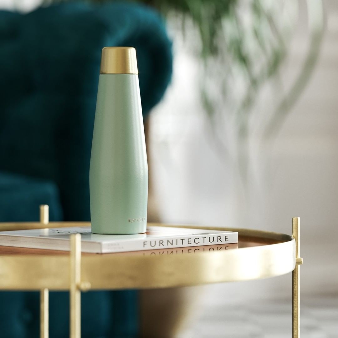 The water bottle on a gold coffee table