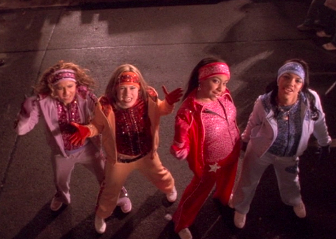 The Cheetah Girls wearing cheetah pattered outfits of different colors
