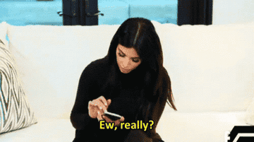 GIF of Kim K texting and saying, &quot;Ew, really?&quot;