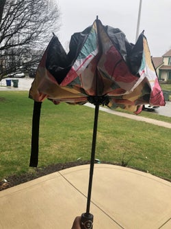 same umbrella partially open showing the reversed design