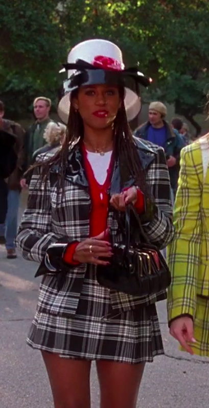 Dionne wearing a matching plaid outfit and a very large hat