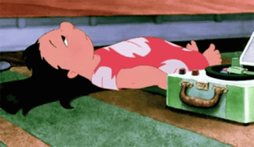 GIF of Lilo laying on the ground putting on a record