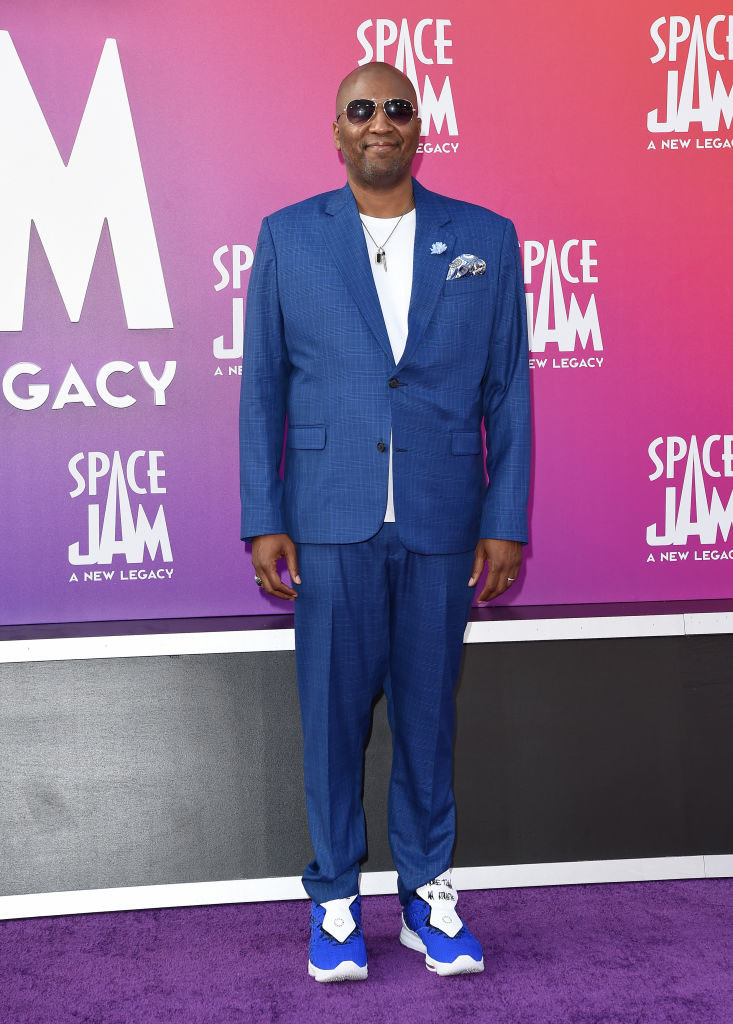Malcolm D. Lee attends the premiere in a suit and sneakers