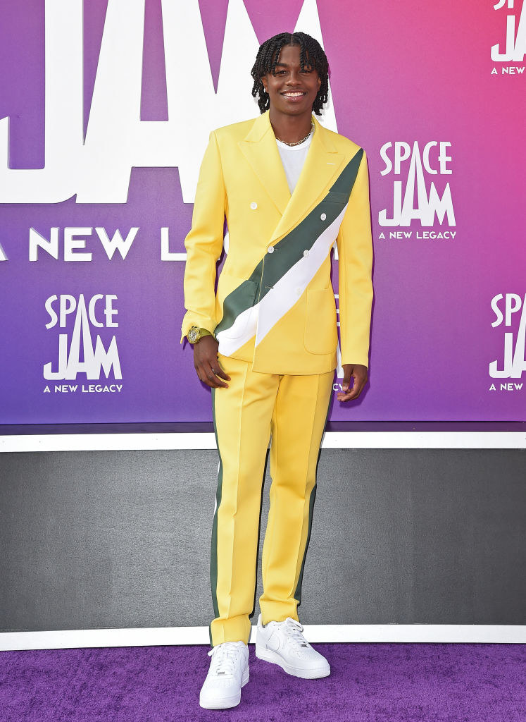 Ceyair J Wright attends the premiere in a fitted suit
