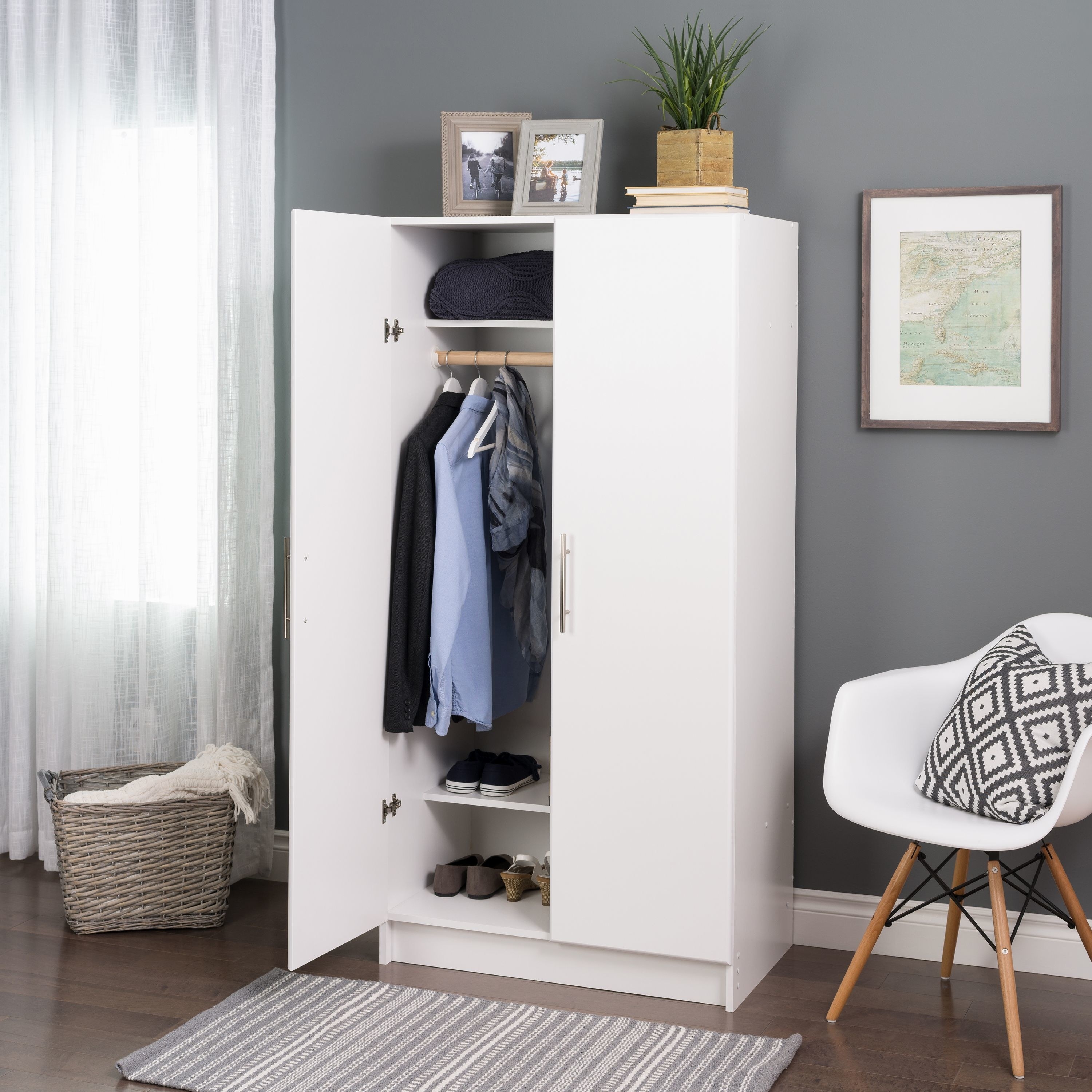 white wardrobe cabinet with clothing rod and shelves inside