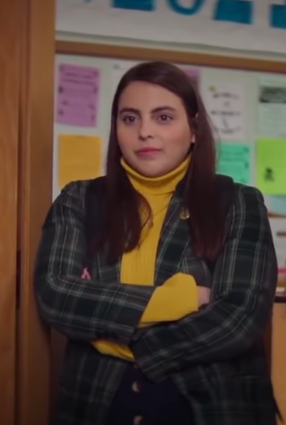 Amy wearing tights, a mini skirt, a turtleneck, and a blazer