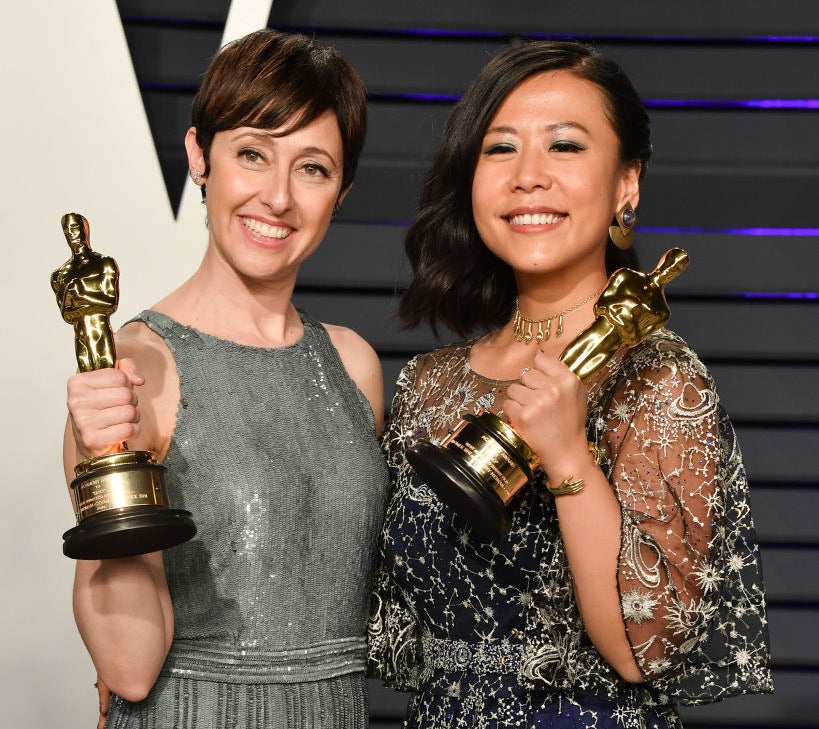 Domee posing with her Oscar backstage with a fellow Oscar winner