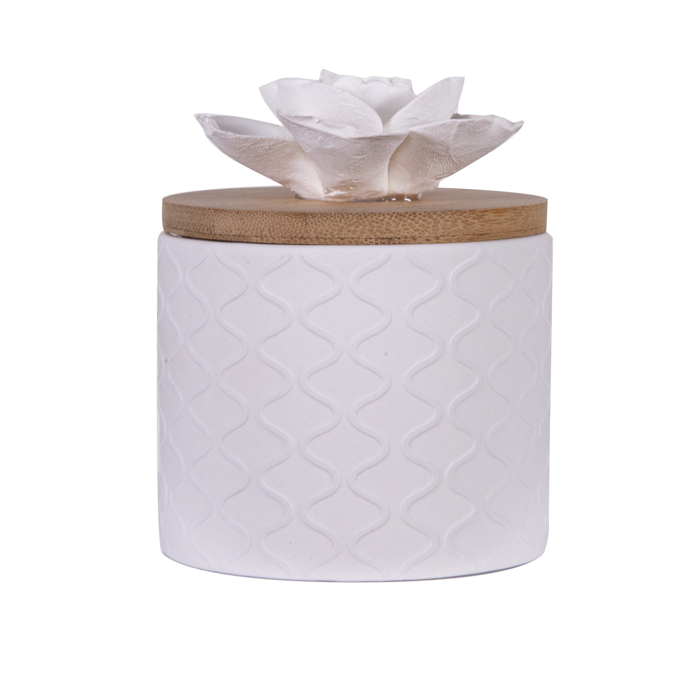 white cylindrical diffuser with lid and ceramic flower on top