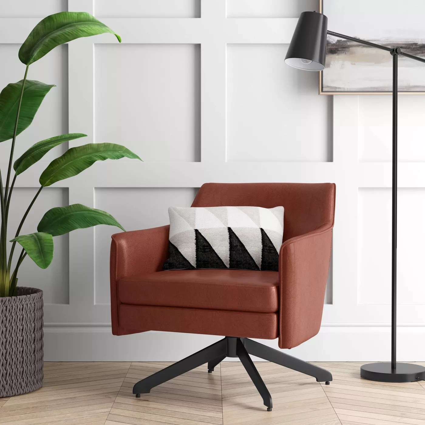 The brown chair with a black swivel base in a living room