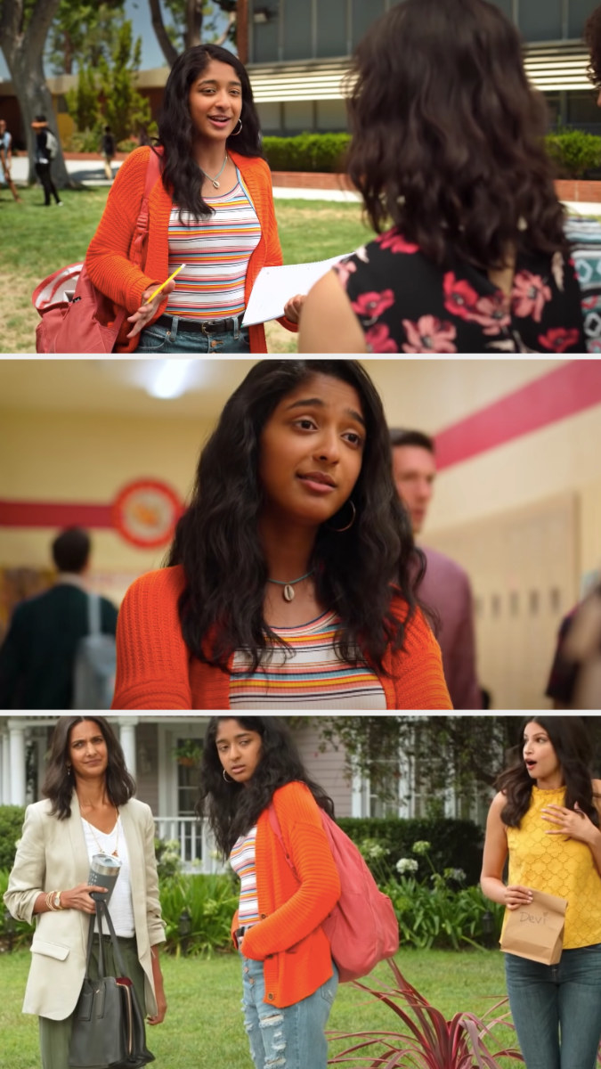 Devi wearing an orange cardigan, stripe tank top, and some distressed blue jeans