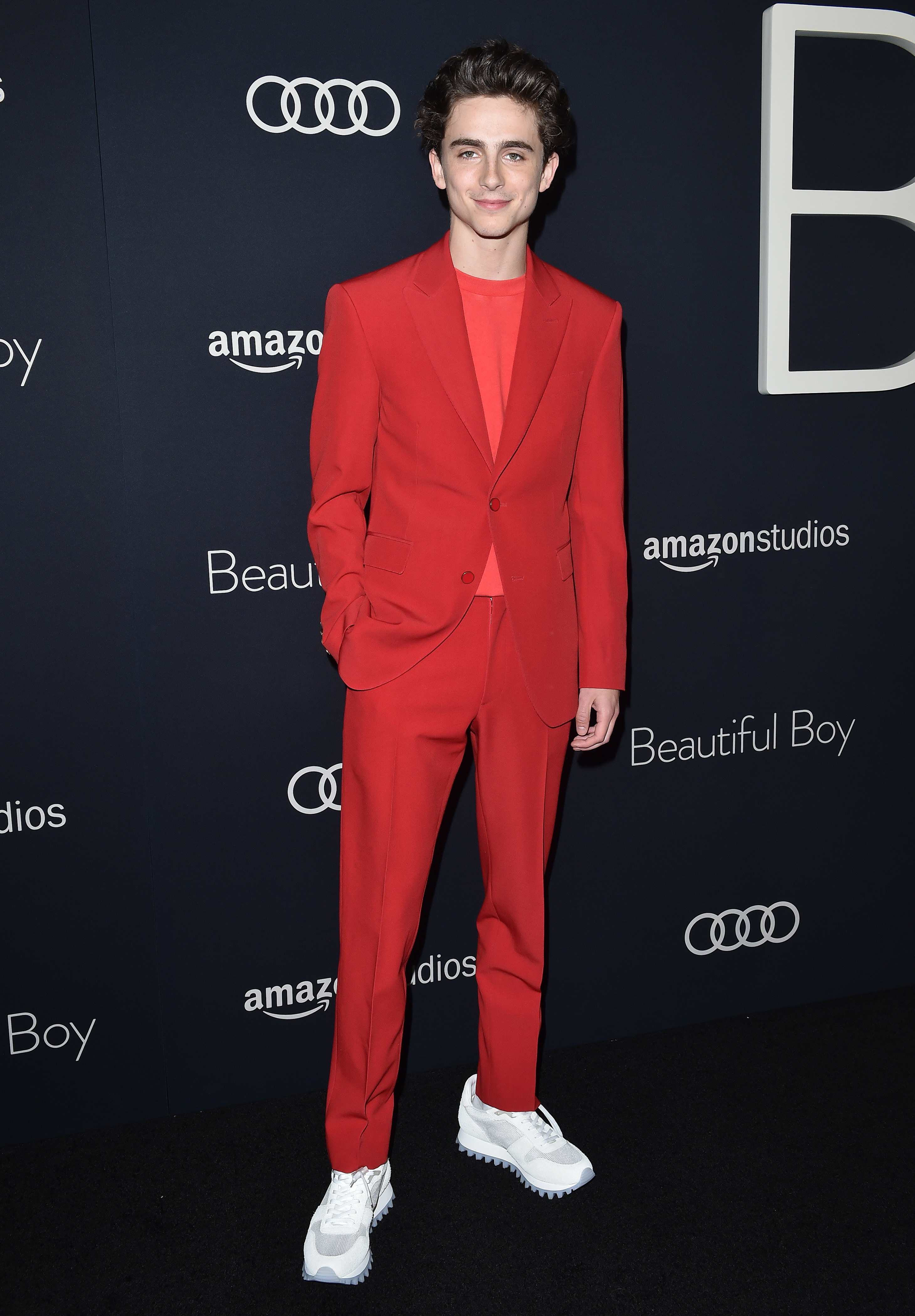Timothée wears a red suit with a red T-shirt