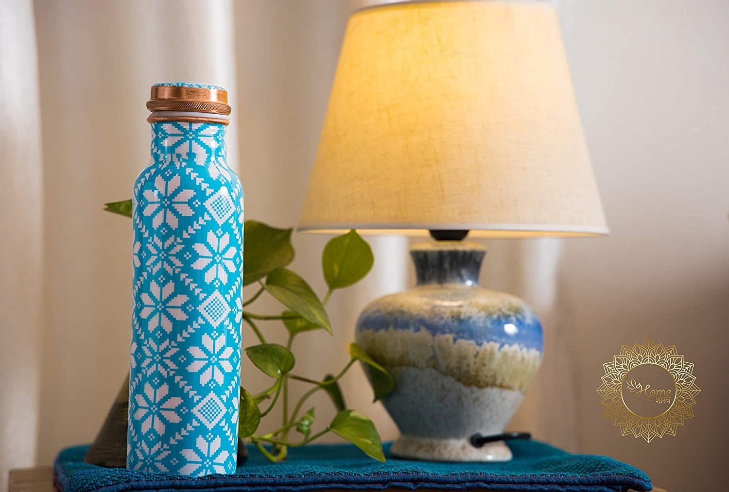 A copper bottle with blue and white snowflakes printed on it