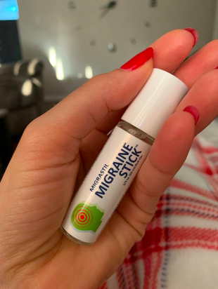 reviewer holding the stick in their hand 