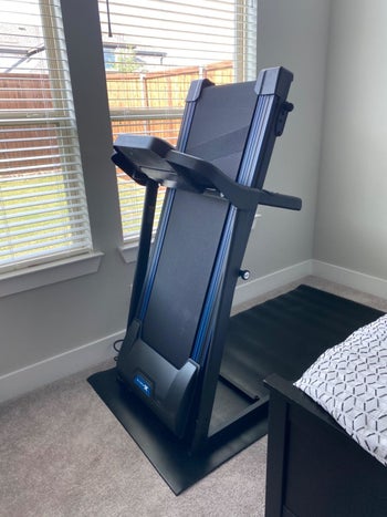 same reviewer's photo of the treadmill folding up
