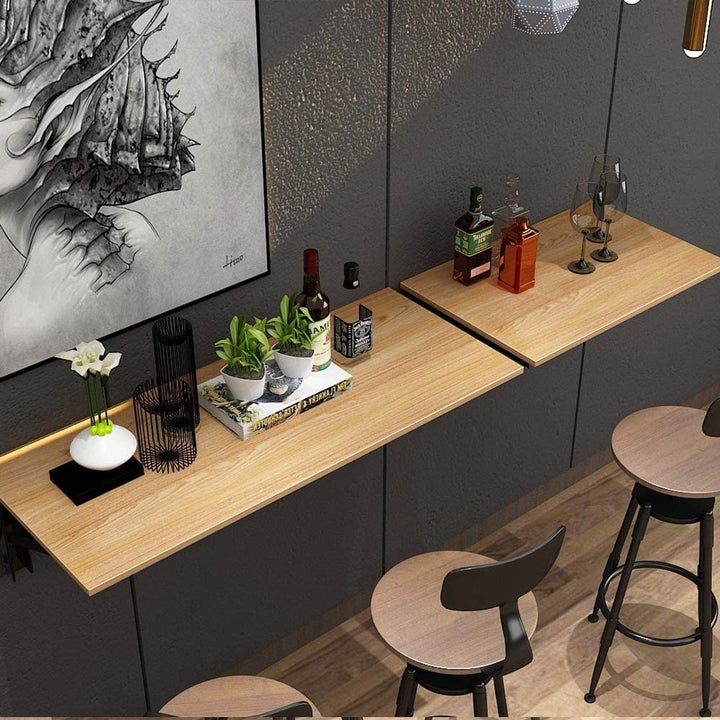 the unfolded desk on a wall