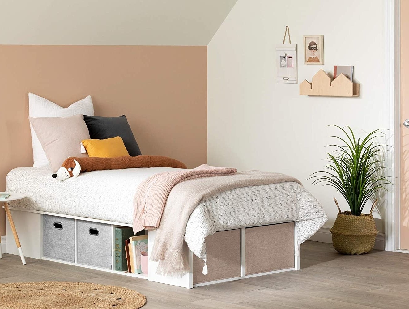 a bed on the storage bed frame in a cute room