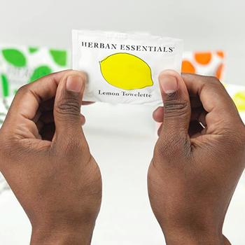 hands holding up a lemon packet 