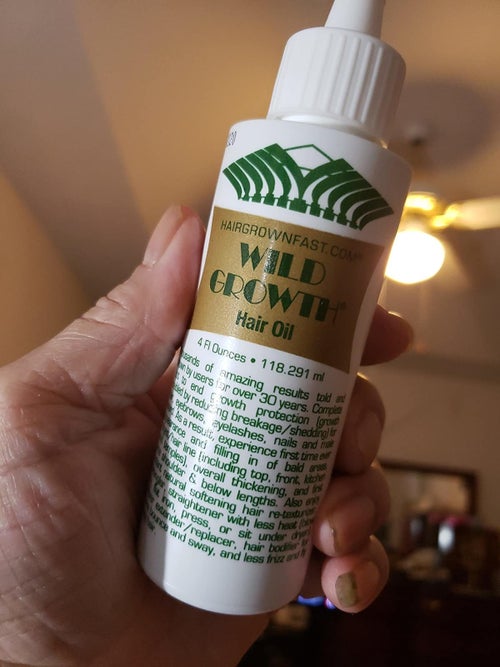 Reviewer holding product in hand