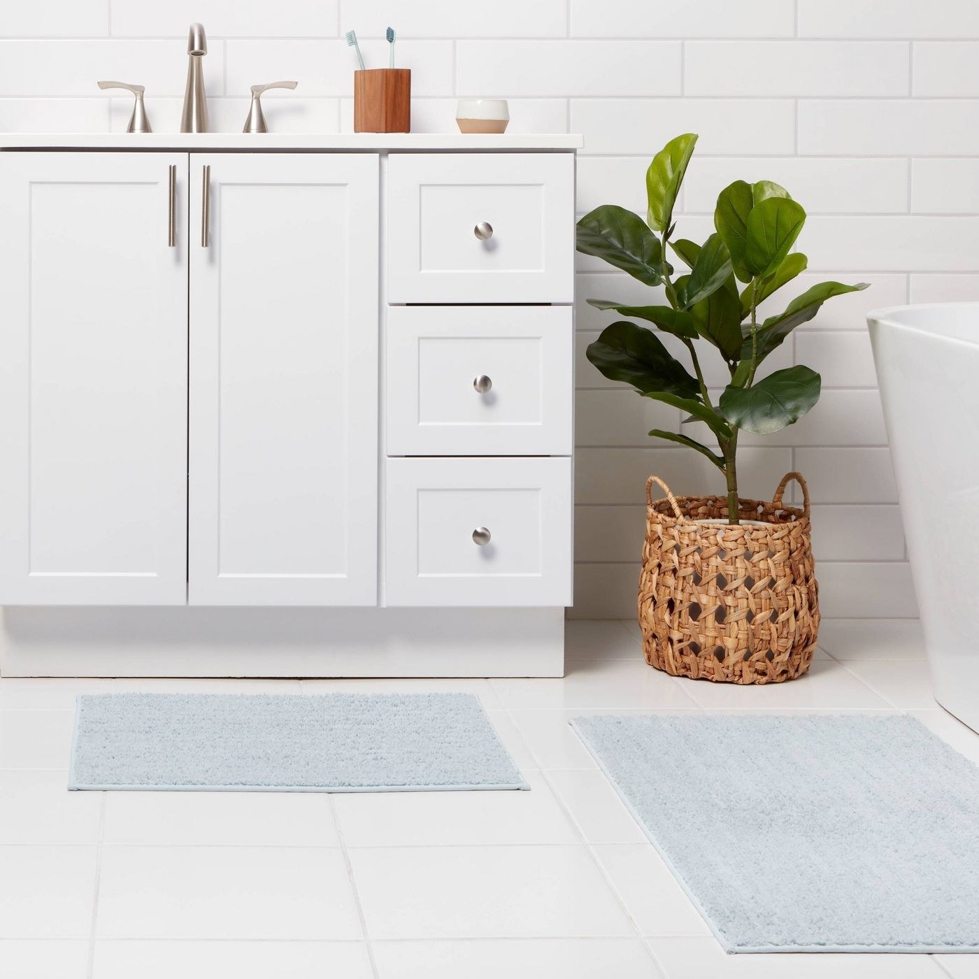 two light blue bath mats staged in a bathroom