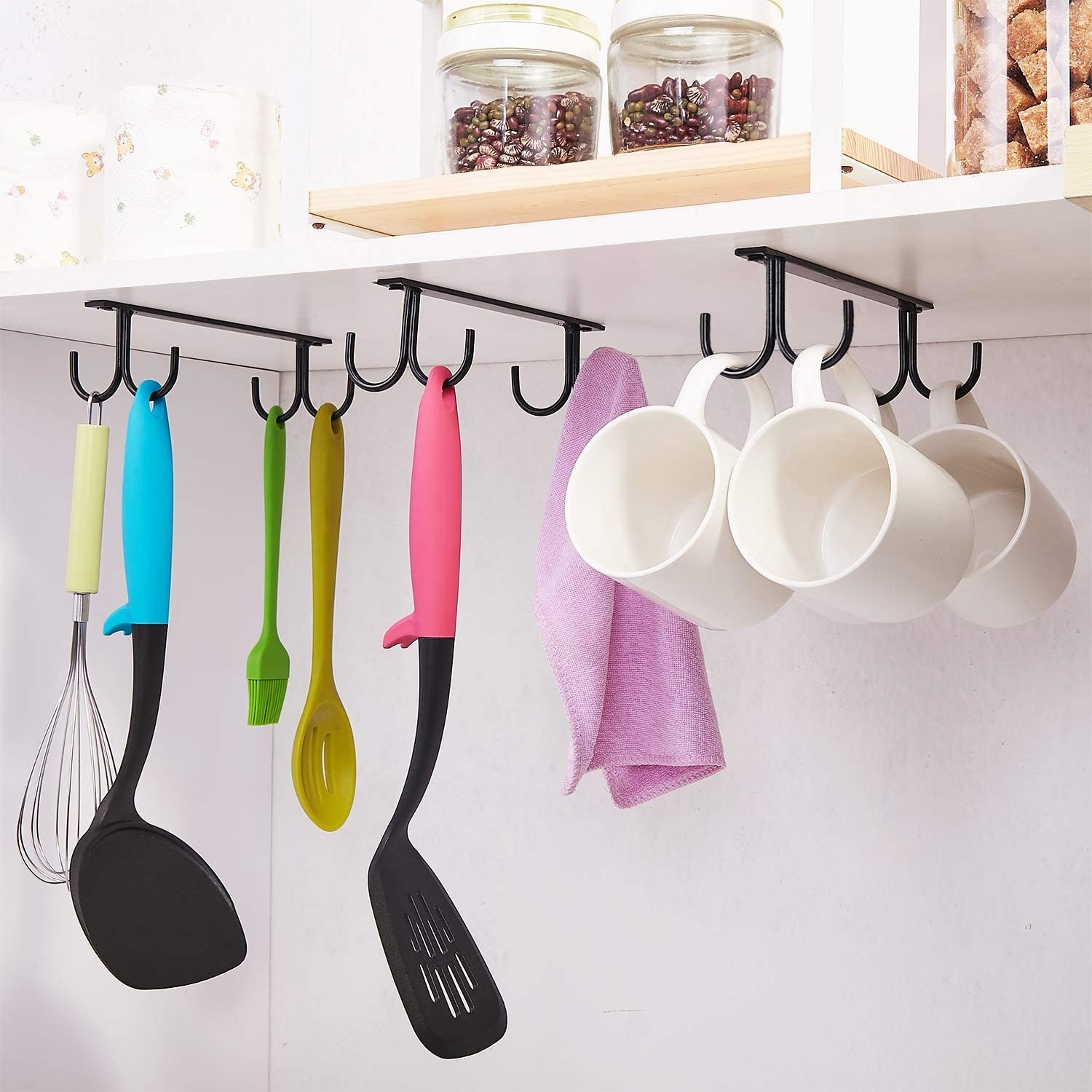 mugs and spatulas hanging off of the mounted hooks